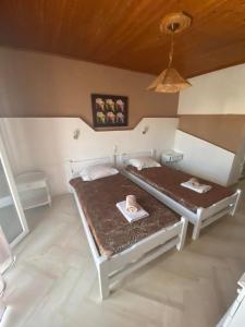 a bedroom with two beds in a room at Angela - Zoi Rooms in Skiathos Town
