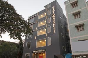 a building with a sign on the side of it at OYO Townhouse 093 Ramamurthy Nagar Near Baiyappanahalli Metro Station in Bangalore