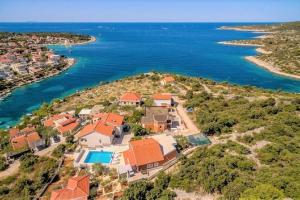 an aerial view of a house on a island in the water at Apartments Matan in Sevid