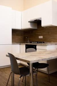 a kitchen with a wooden table and chairs in it at Special house in Salerno