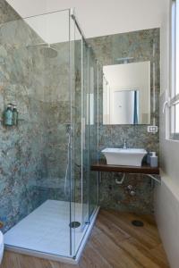 a bathroom with a glass shower and a sink at Domus Angioina in Naples