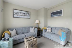 a living room with two couches and a couch at La Petite Maison Apartments in Brixham