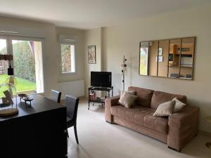 Μια τηλεόραση ή/και κέντρο ψυχαγωγίας στο Appartement Cosy, tout confort, à deux pas de la mer
