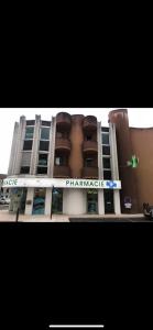 a building with a pharmacy sign in front of it at Appartement de 110m2 au centre de Cusset in Cusset