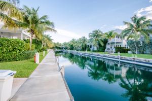 a canal of water with palm trees and houses at Coral Lagoon Resort in Marathon