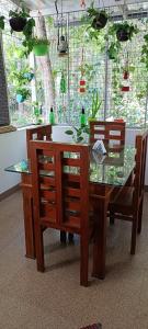 a dining room table with chairs and a glass table at Oyster Marris Homestays Thiruvananthapuram Award winning Homestay in Trivandrum