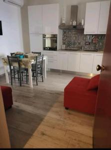 a kitchen and living room with a table and chairs at Casa Vacanze Dany in Taranto