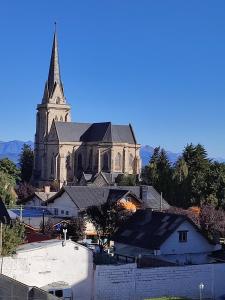 a large church with a steeple on top of it at Lofts Patagonia Mitre 3 in San Carlos de Bariloche