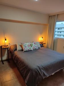 a bedroom with a large bed with two lamps at Lofts Patagonia Mitre 3 in San Carlos de Bariloche