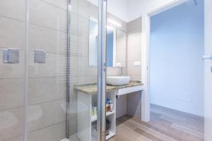a bathroom with a sink and a shower at Malibò, Bologna By Short Holidays in Bologna +11 photos