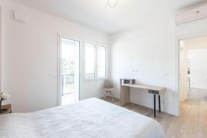 a white bedroom with a desk and a bed at Malibò, Bologna By Short Holidays in Bologna