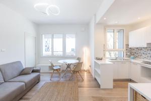 a white living room with a couch and a table at Malibò, Bologna By Short Holidays in Bologna