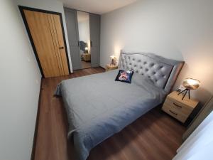 a bedroom with a bed with a pillow on it at City apartment 2 bedrooms in Šiauliai +23 photos
