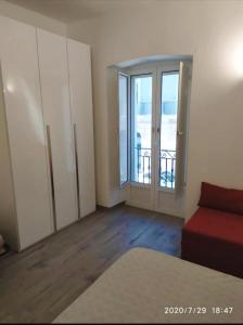 a room with a couch and a sliding glass door at Casa Vacanze Dany in Taranto