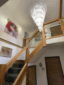 a staircase with a chandelier in a house at The Waters Edge Guest House in Stratford-upon-Avon