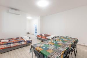 two beds in a room with white walls at Gobetti, Bologna by Short Holidays in Bologna