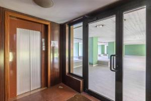a room with glass doors and a room with a hallway at Gobetti, Bologna by Short Holidays in Bologna