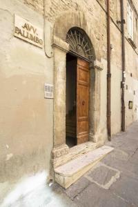 a building with a wooden door on the side of it at Elegant flat in the city centre with two suite in Perugia
