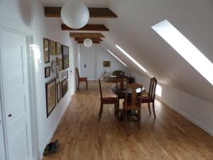 a dining room and living room with a table and chairs at Hesselhogaard Bed & Breakfast in Grindsted