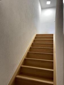 a staircase in a building with wooden steps at Apartament cozy in Villerupt