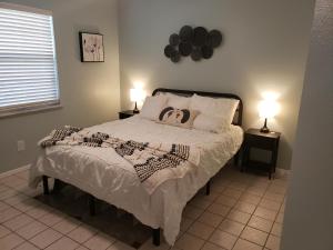 a bedroom with a large bed with two lamps at Venice Gardens, 2-Br Pet Friendly Home - Indra in Venice