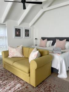 a living room with a couch and a bed at African Flame Apartment in Knysna