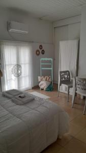 a bedroom with a large bed and a chair at Amarello in Gualeguaychú