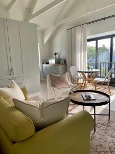 a living room with a couch and a table at African Flame Apartment in Knysna
