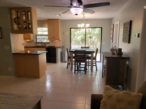 a kitchen and living room with a table and chairs at Venice Gardens, 2-Br Pet Friendly Home - Indra in Venice
