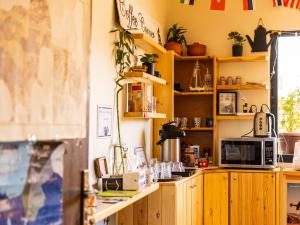 a kitchen with wooden cabinets and a microwave at Hakaia Community in Aqaba