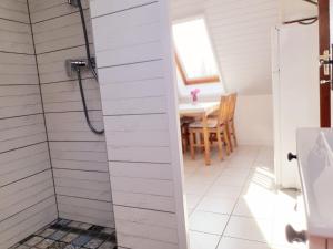 a bathroom with a shower and a table at Lavendel apartments in Hévíz