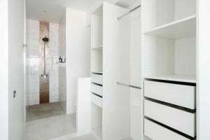 a white bathroom with a walk in shower at Best View Apartment in Koh Samui 