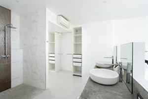 a white bathroom with two sinks and a tub at Best View Apartment in Koh Samui 