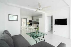 a living room with a couch and a table at Best View Apartment in Koh Samui 