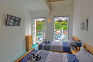a bedroom with two beds and a view of a pool at Ultimate Harbourside in Ilfracombe
