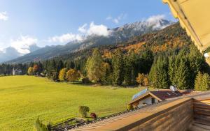 a view of a field and mountains from a house at Gasthof Rechenhof in Innsbruck