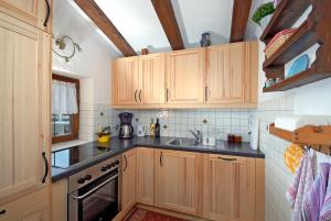 a kitchen with wooden cabinets and a sink at Chalet Nina in Reith im Alpbachtal