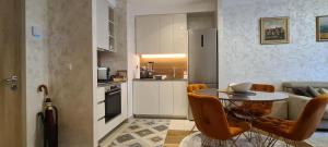 a kitchen and a living room with a table and chairs at Premium NB Apartment - Belgrade Waterfront in Belgrade