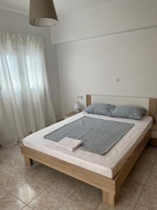 A bed or beds in a room at G.S Ialysos Holiday Apartment