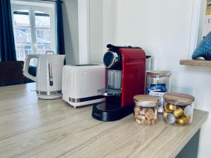 a kitchen counter with a coffee maker and a toaster at Studio Remigny, hyper centre ville de Nevers, style "Appart-hôtel" by PRIMO C0NCIERGERIE in Nevers