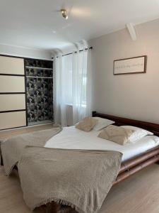 a bedroom with a large bed and a window at VILLA KER BLEUENN * 10 PERSONNES * PISCINE * SAUNA in La Fresnais