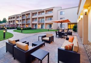 a patio with couches and tables and a building at Courtyard by Marriott Huntsville University Drive in Huntsville