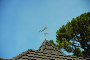 a weather vane on the top of a roof at L'Auberge Carmel, Relais & Chateaux in Carmel