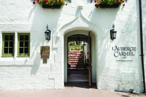 an entrance to a white building with a doorway at L'Auberge Carmel, Relais & Chateaux in Carmel
