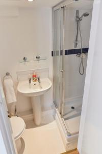 a bathroom with a shower and a sink and a toilet at The Union Penthouse in Oxford