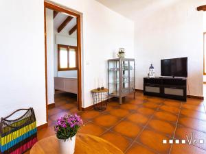 a living room with a tiled floor and a flat screen tv at VH CostaBlanca - OSALVA in Benissa