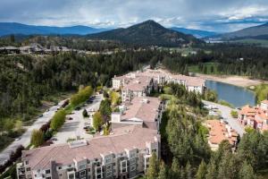 an aerial view of an apartment complex with mountains in the background at Gorgeous Condo, Perfect Okanagan Getaway 1207 in Kelowna