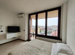 um quarto com uma cama e uma grande janela em Parcheggio Privato - Appartamento a Milano em Corsico