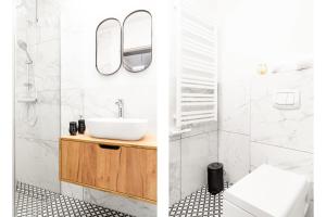 a bathroom with a sink and a mirror at HOUSEHOST Apartment: Św.Gertrudy 10/0.2 in Krakow