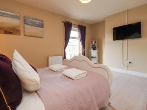 a bedroom with a bed with two towels on it at 21 West View in Clitheroe